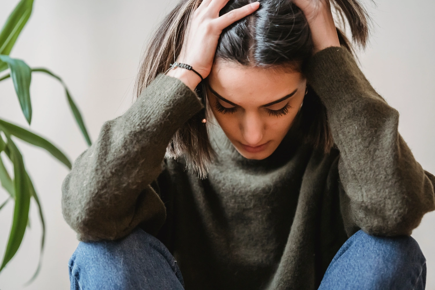 woman with anxiety rubbing her head